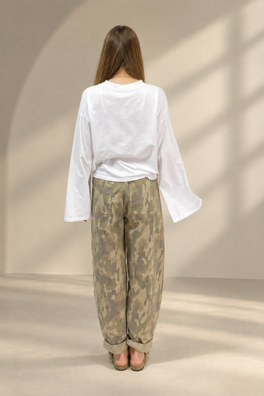 T-shirt Basic bianca, vista posteriore su sfondo greige da studio
